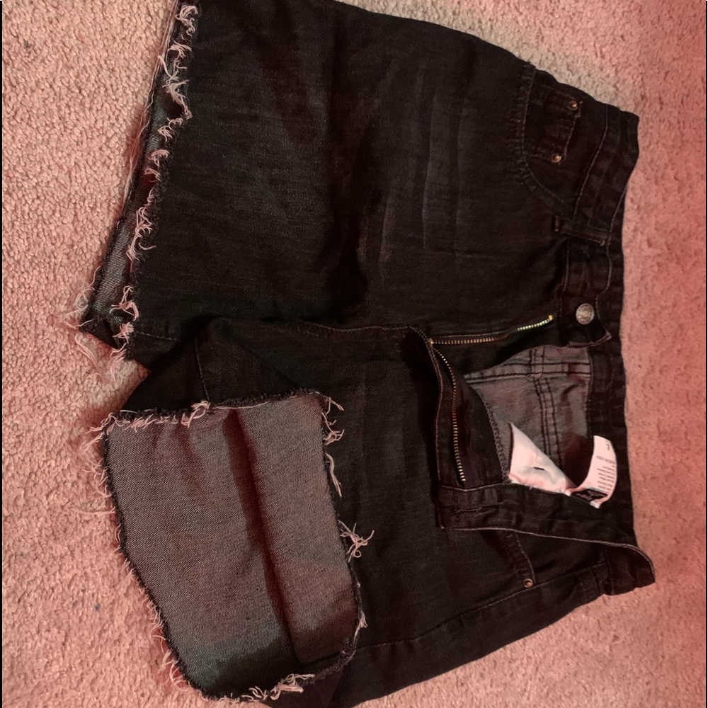 Black Jean shorts, distressed ends.